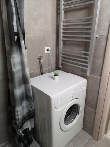 a washing machine with a plant on top of it at Dimitris House 7 in Thessaloniki