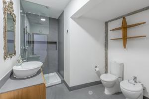 a bathroom with a sink and a toilet and a mirror at Lisbon Downtown Apartment Figueira in Lisbon +20 photos