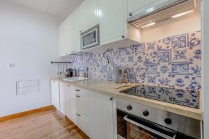 a kitchen with blue and white tiles on the wall at Lisbon Downtown Apartment Figueira in Lisbon
