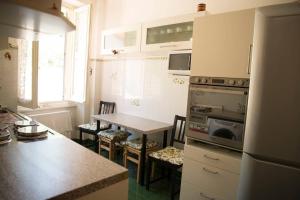 a kitchen with a table and chairs in a kitchen at Casa della Posta in Borzonasca +24 photos