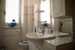 a bathroom with a sink and a toilet at Casa della Posta in Borzonasca