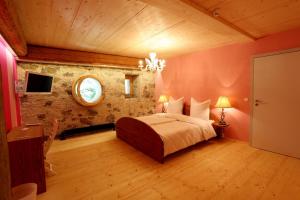 a bedroom with a large bed in a room at hotel rainhof scheune & naturpark restaurant (Kirchzarten) in Kirchzarten