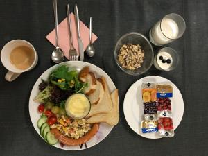 a table with two plates of food and two plates of food at Hotel Ko in Düsseldorf