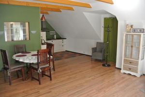 a kitchen and dining room with a table and chairs at FEWO Elbe Weser in Hipstedt