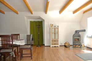 a living room with a wood stove and a green door at FEWO Elbe Weser in Hipstedt