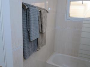 a bathroom with towels hanging on a wall at Brisas del Mar in Los Abrigos