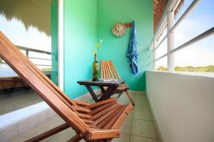 
a wooden bench sitting in front of a window at La Palmita Budget Boutique Hotel in Tulum
