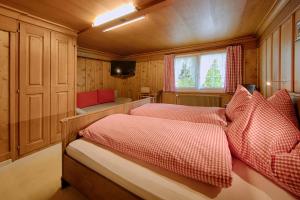 1 Schlafzimmer mit 2 Betten mit roten und weißen Kissen in der Unterkunft Hotel Frohe Aussicht in Weissbad