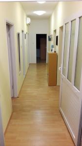 an empty hallway in a hospital with a door at House Zara in Maslenica