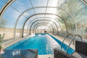 an indoor swimming pool with a glass ceiling at Apartment Crikvenica 7 in Crikvenica