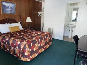 a hotel room with a bed and a sink at Mother Lode Lodge in Mariposa
