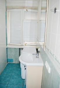 a bathroom with a white sink and a window at Hostel Golden Gates in Kyiv +52 photos