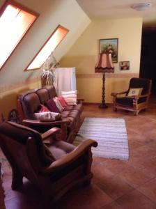 a living room with a couch and two chairs at Főnix Fogadó in Lenti