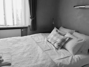 Una cama con sábanas blancas y almohadas en un dormitorio en MARIENSZTAT - 2 ROOMS OLD TOWN, en Varsovia
