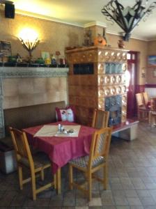 a dining room with a table and chairs in a room at Főnix Fogadó in Lenti