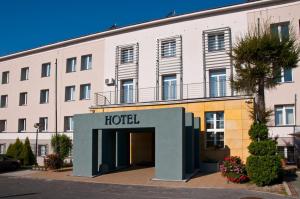 a hotel in front of a large building at Brojan in Jaworzno