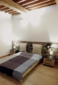 a bedroom with a large bed with a wooden headboard at Giulia in S.Reparata in Florence