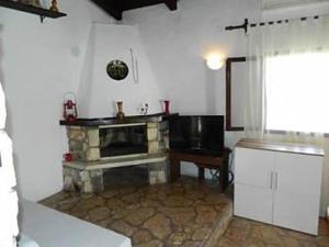 a kitchen with a stone fireplace in a room at Holiday home Ivica - by the sea in Sevid