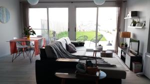 a living room with a couch and a table at Amazing view to the sea & port bay in Mosteiros in Mosteiros