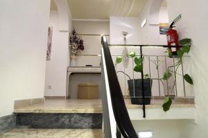 a living room with a fireplace and a plant at Casa Da Praia "AL" in Monte Gordo