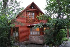 a log cabin in the woods with trees at Cabanas Inti-Wari Jujuy in El Ceibal