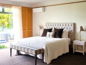 a bedroom with a large bed and a window at Mt Michael Lodge in Cromwell