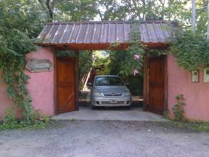 a car parked in a garage with a rusty roof at Cabanas Inti-Wari Jujuy in El Ceibal +2 photos