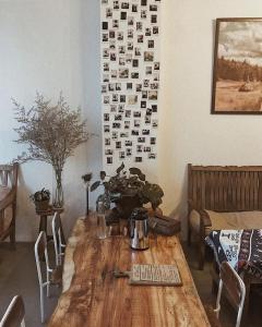 a wooden table in a living room with a table at ÉTÉ Dalat in Da Lat