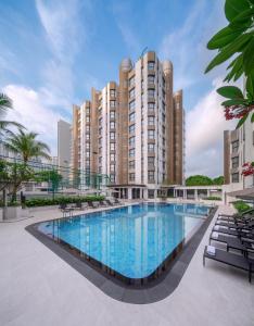 a large swimming pool in front of a large building at Le Grove Serviced Residences in Singapore