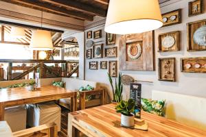 a restaurant with wooden tables and pictures on the walls at Tiki Limbo in Montañita