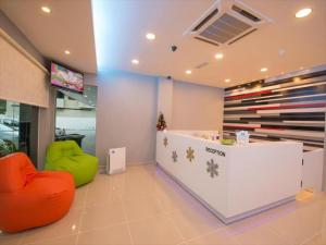 a store lobby with two chairs and a counter at G Langkawi Motel in Kuah