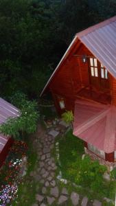 a house with a red roof and a stone walkway at Cabanas Inti-Wari Jujuy in El Ceibal