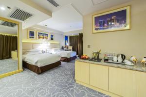 Voodi või voodid majutusasutuse Metropark Hotel Macau toas