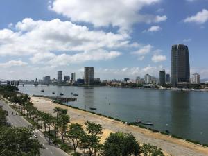 a large body of water with a city in the background at Vitalis Riverside Hotel in Danang
