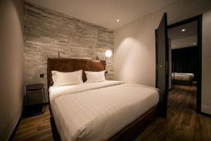 Postel nebo postele na pokoji v ubytování Eureka Hotel Penang