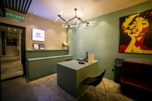 a lobby with a desk and a chair in a room at Eureka Hotel Penang in Bayan Lepas