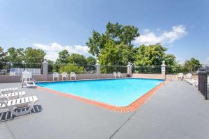 a large swimming pool with chairs at Ramada Limited Cockeysville in Cockeysville