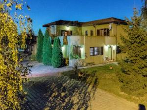 an exterior view of a house with a yard at Toscana Villa in Snagov