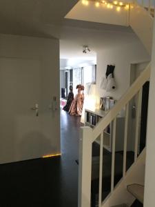 two women in dresses walking down a hallway at Großes helles Zimmer + eigenes Bad in Hamburg