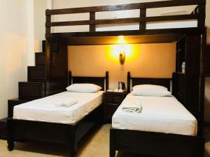 Postel nebo postele na pokoji v ubytování My Vigan Home Hotel