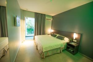 a hotel room with a bed and a window at G Langkawi Motel in Kuah