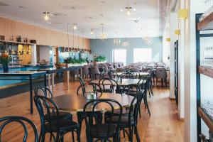 a dining room with tables and chairs and a bar at Rönneberga in Lidingö