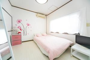 Una cama o camas en una habitación de Miraie Yokkaichi Kitahamacho