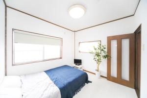 Una cama o camas en una habitación de Miraie Yokkaichi Kitahamacho