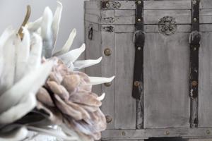 a wooden chest with a flower in front of it at White Pearls-Adults Only Luxury Suites in Kos