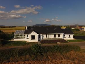 a white house with solar panels on it at The Greene House in Limavady