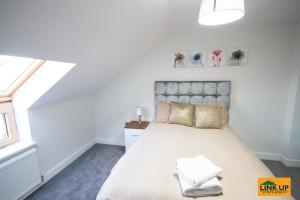 a bedroom with a large bed and a window at Holden Court Apartments - Apt 6 in West Drayton