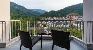 a balcony with a table and chairs and a view at The Bayview Beach Resort in Batu Ferringhi