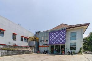 a purple building with motorcycles parked in front of it at RedDoorz near Goa Sunyaragi in Cirebon