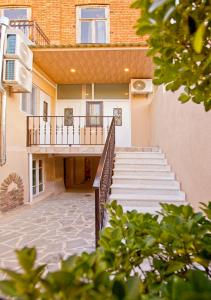 a staircase leading to a building with a balcony at Metekhi Corner Apartments in Tbilisi City